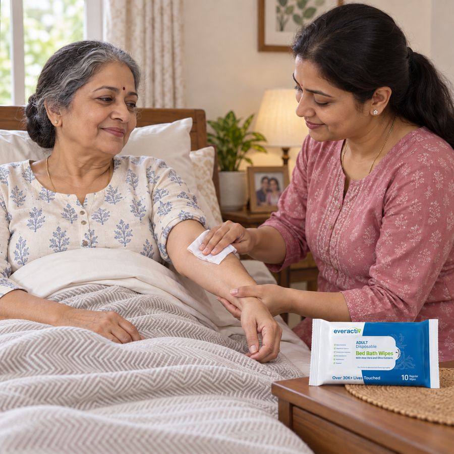 A caregiver gently cleans an older woman’s forearm with an EverActiv Bed Bath Wipe at home. Illustrative care scene.