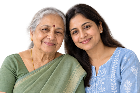 An older Indian mother with her adult daughter, smiling together.